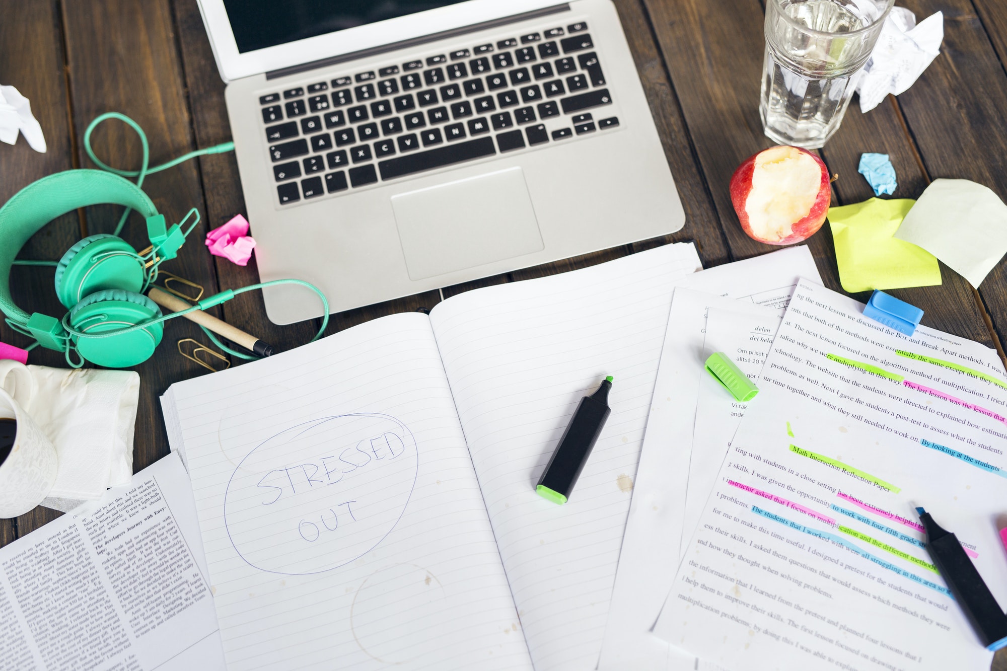 Documents, felt tip pens and laptop on desk